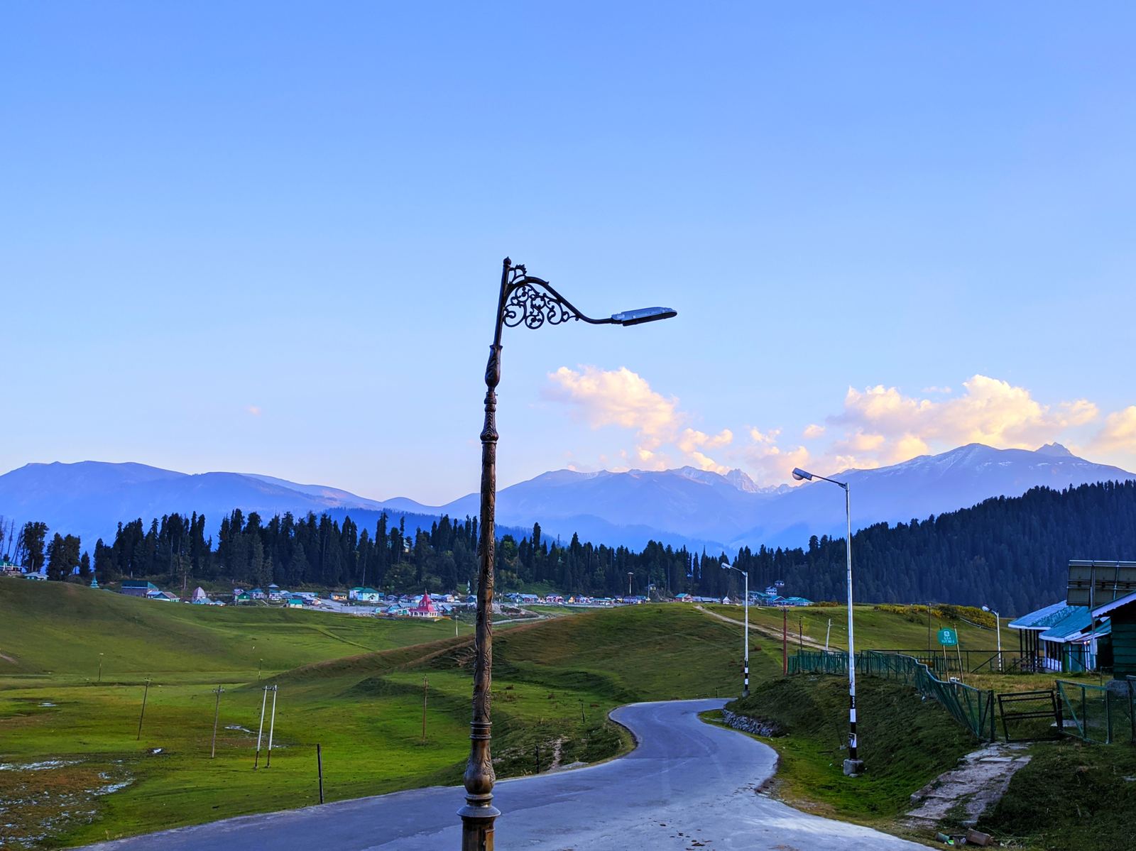Meadow road near Gulmarg at dusk with mountain views